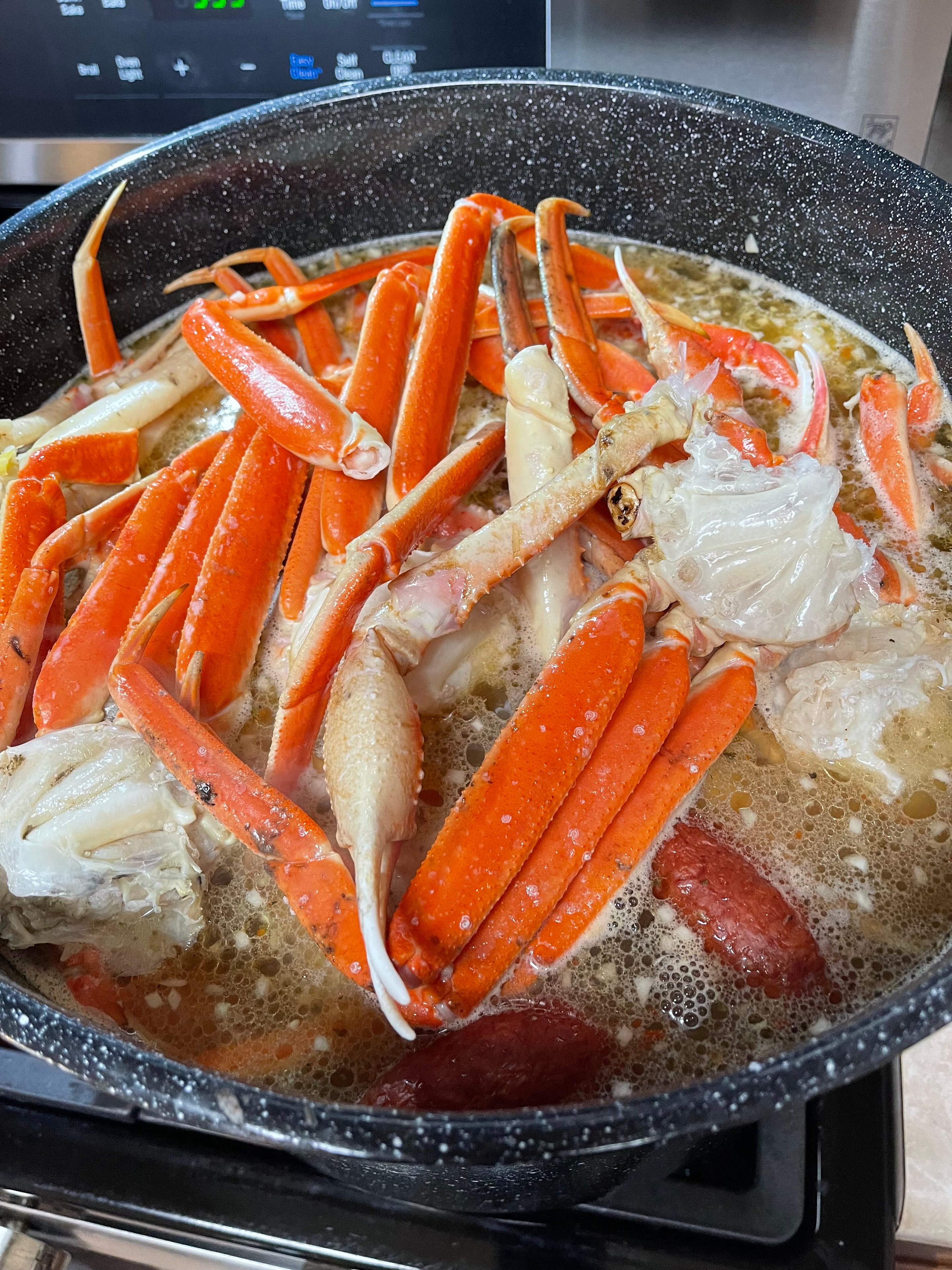 Crab, shrimp and sausage gumbo simmering in a pan
