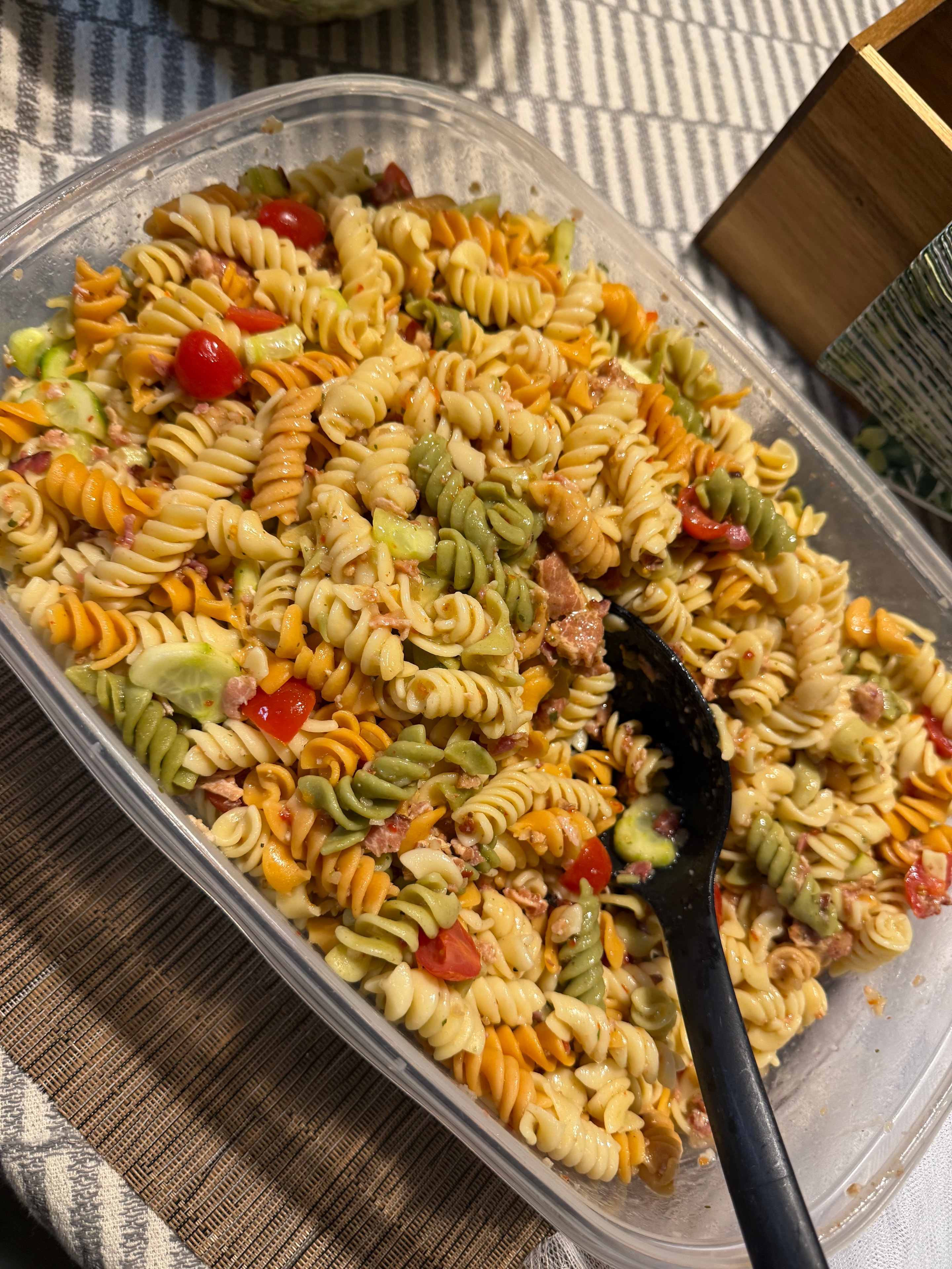 Colorful tri-color pasta salad with vegetables and meat